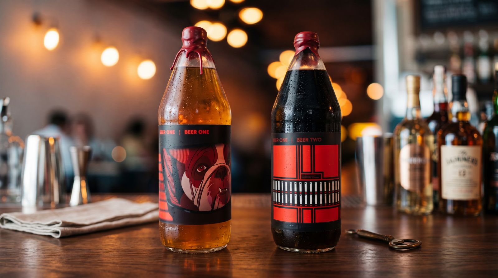 Both Providence Brewing anniversary bottles on a bar with whiskey bottles in the background